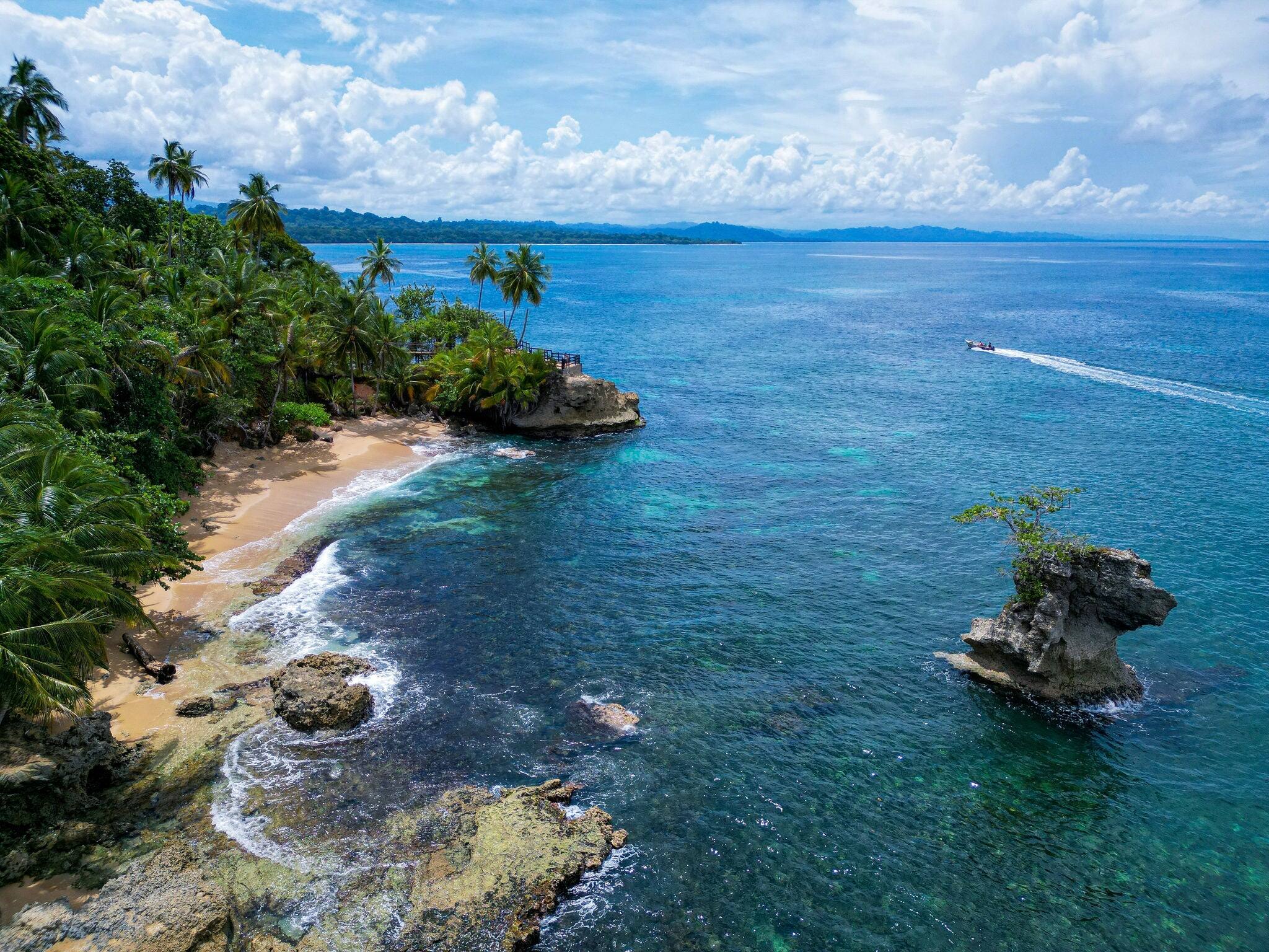 Aerial view of the turquoise waters and emerald rainforest canopy of the Gandoca Manzanillo Costa Rica Nature Reserve