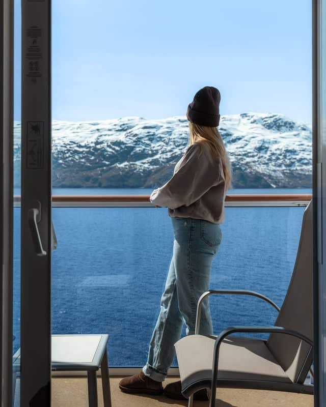 Woman standing on balcony.