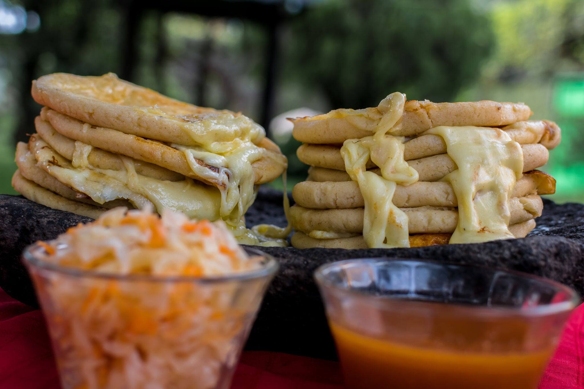 typical Salvadoran dish, cheese pupusas with cabbage and tomato sauce. rice and corn pupusas stuffed with cheese, beans or other ingredients