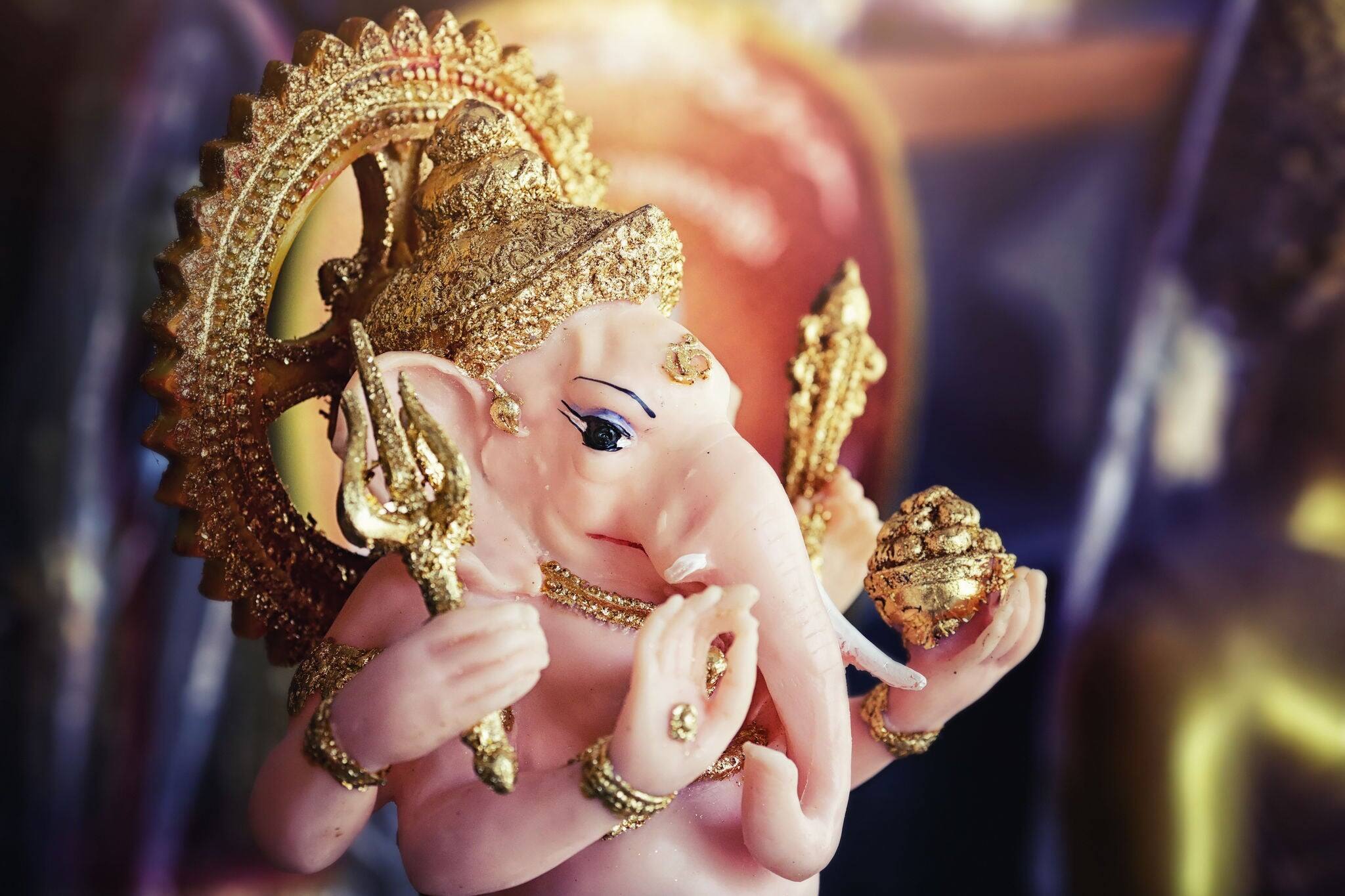 Close-up of hand crafted clay idol of Hindu god Ganesha - Lord of good omen in dramatic light