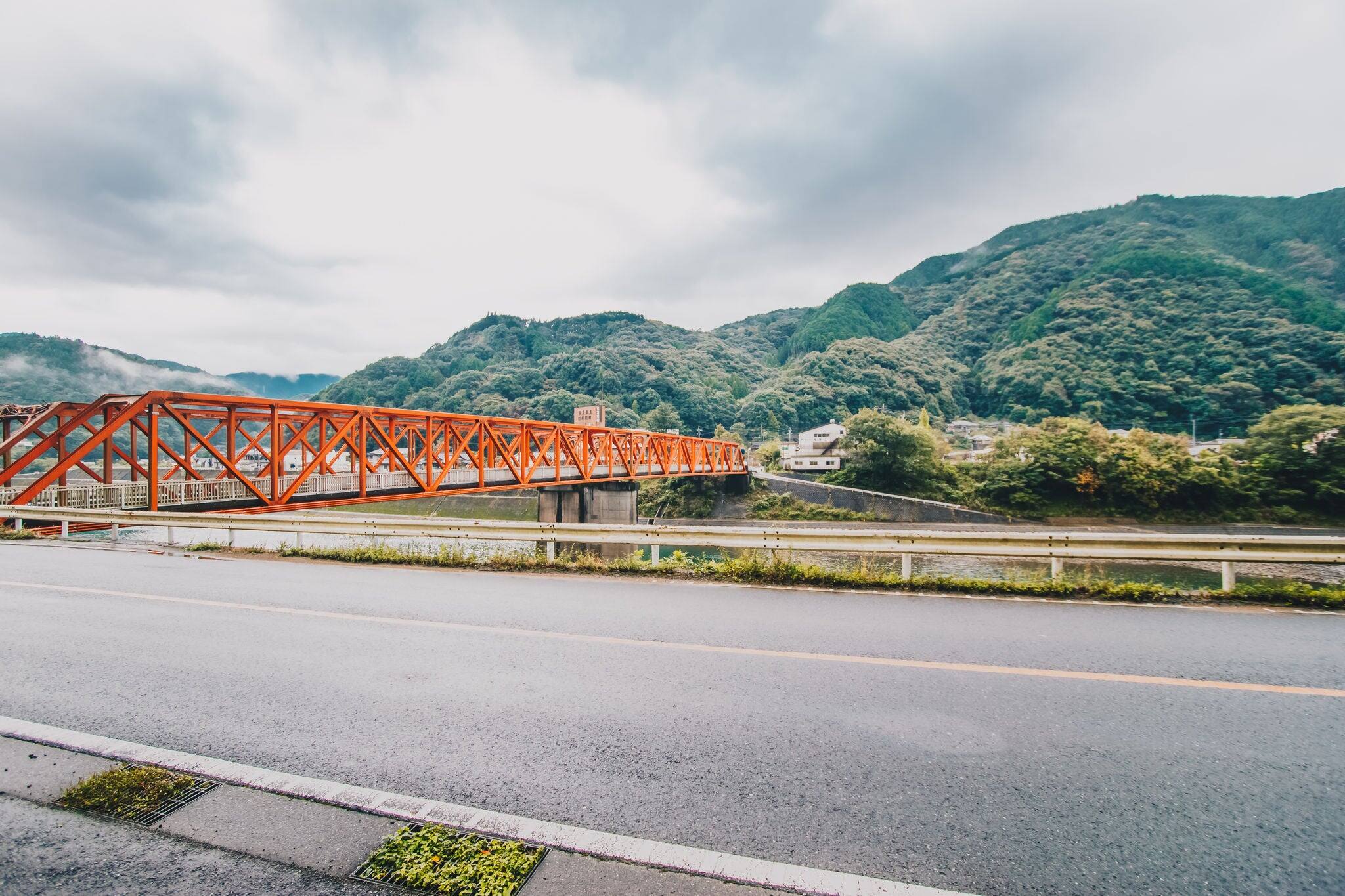 Red iron bridge at Sakamotomachi in heavy rainy day, storm and big cloud is coming, Sakamoto, Yatsushiro, Kumamoto Prefecture.