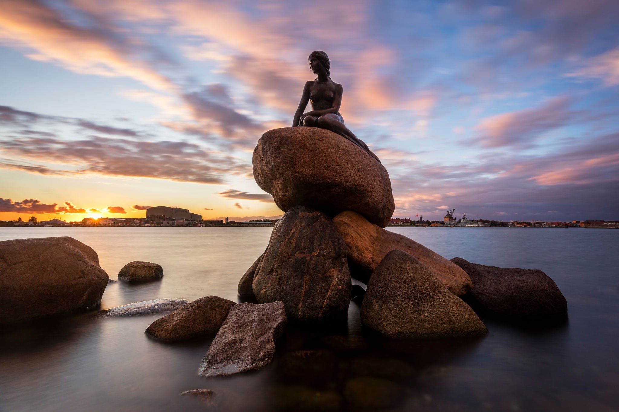 Copenhagen / Denmark - September 8th 2018 - The Little Mermaid in Copenhagen Harbour at Sunrise