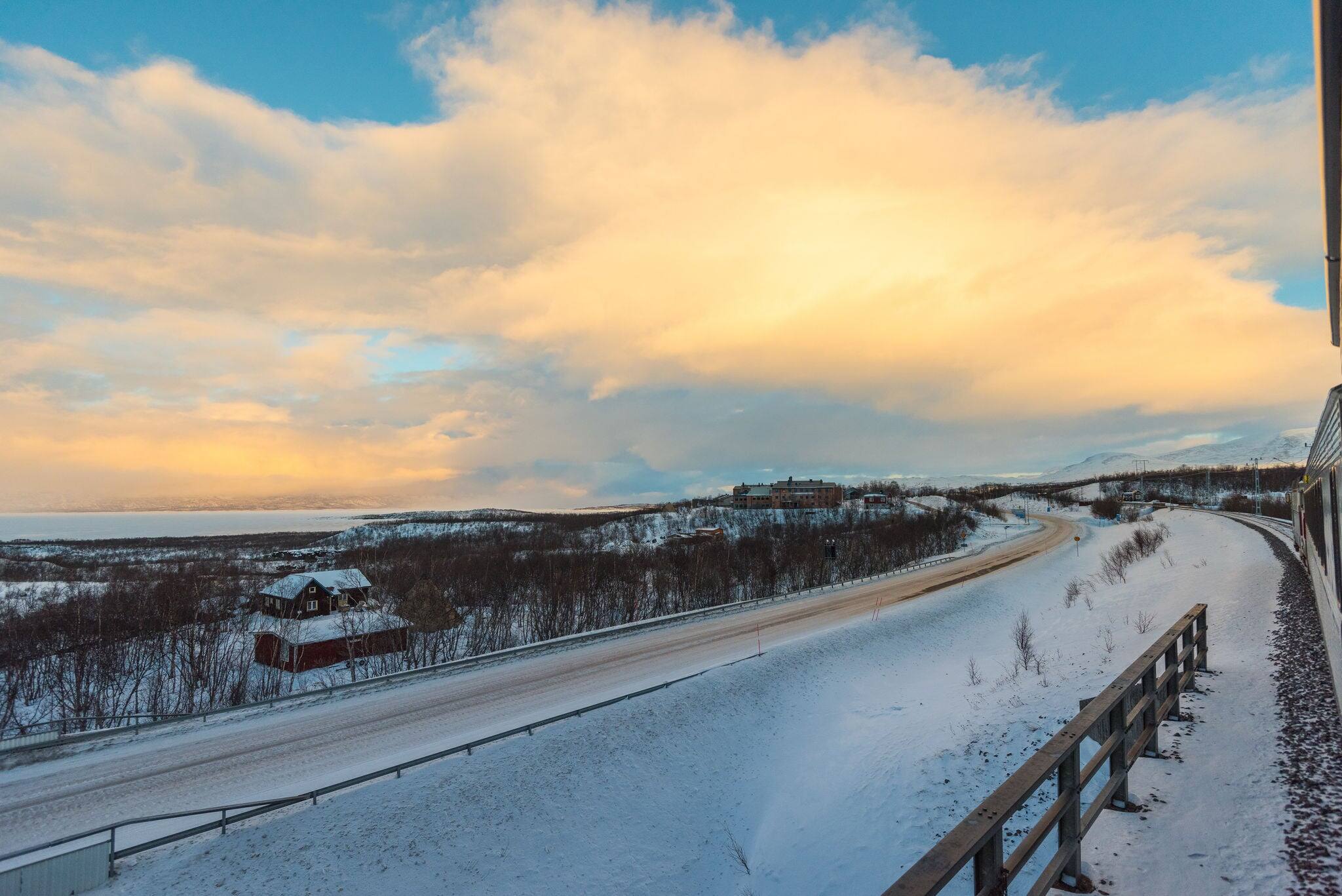 Scenic view of swedish winter landscape in deep snow seen from the night train from Narvik to Stockholm on overcast winter day