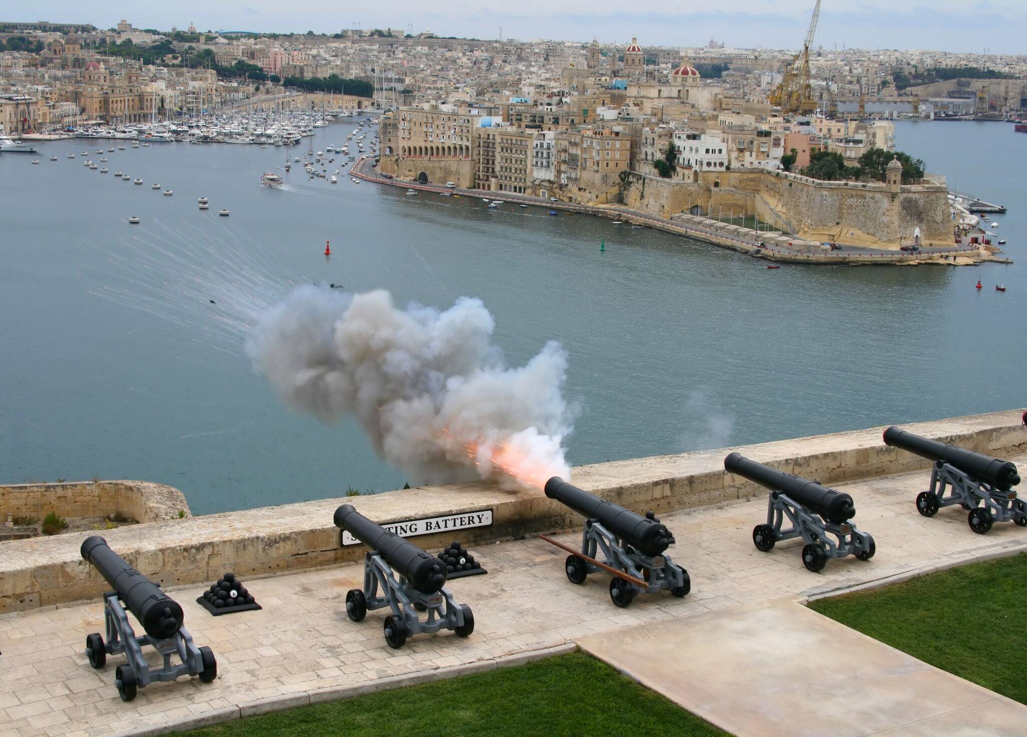 Old cannon shot. Saluting buttery at Upper Barracca Gardens and view of Grand Harbour as a background (Valletta, Malta)