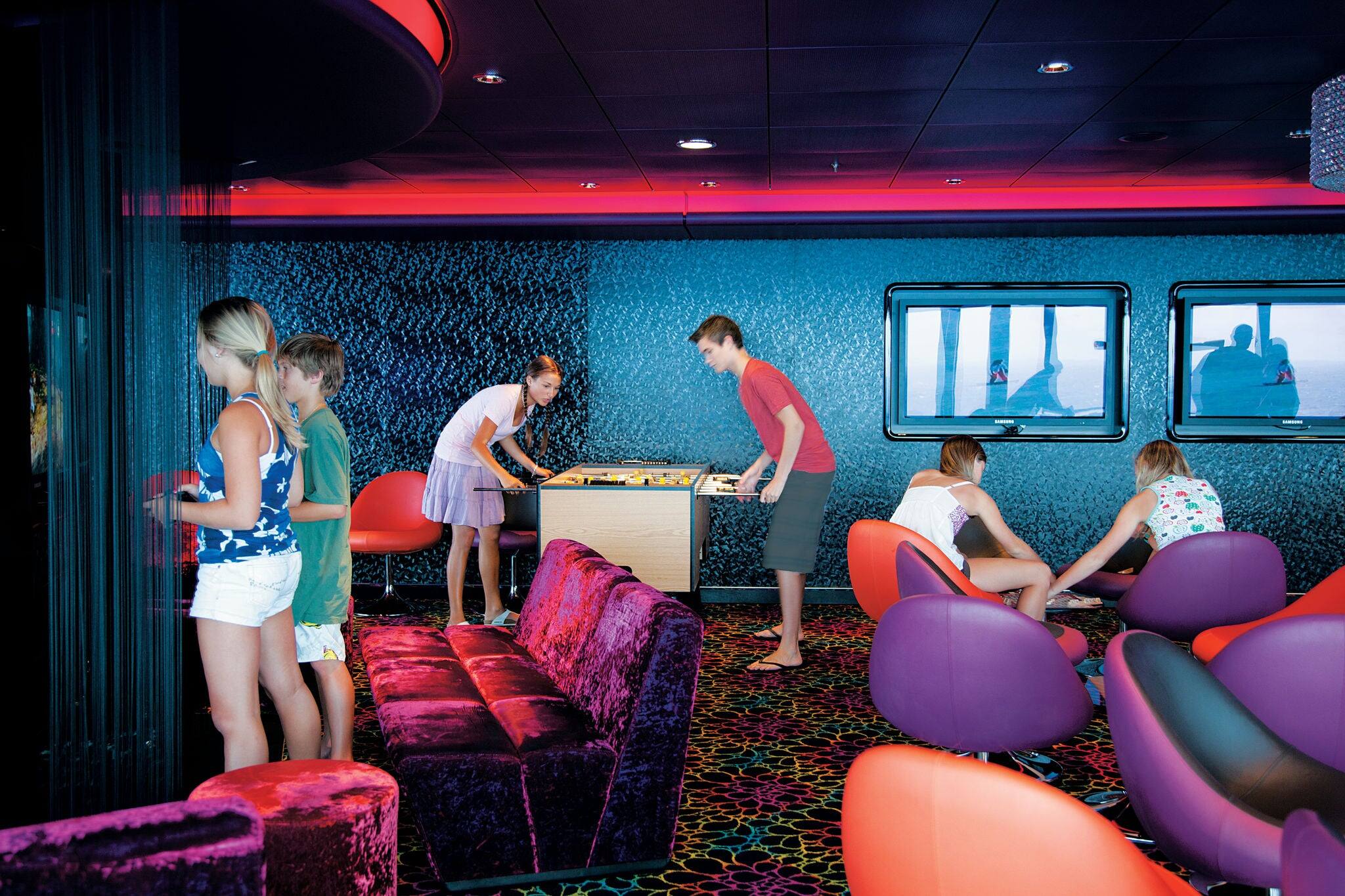 Teens play games and have fun in youth club