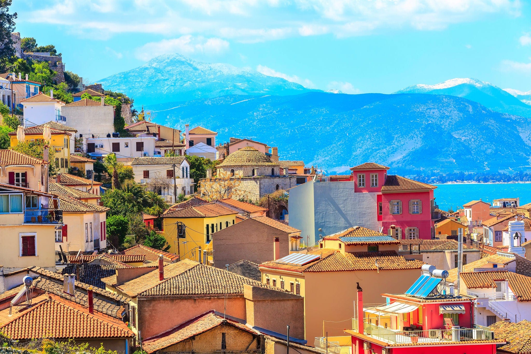 Nafplio or Nafplion, Greece, Peloponnese old town houses aerial panorama with sea and snow mountain peaks