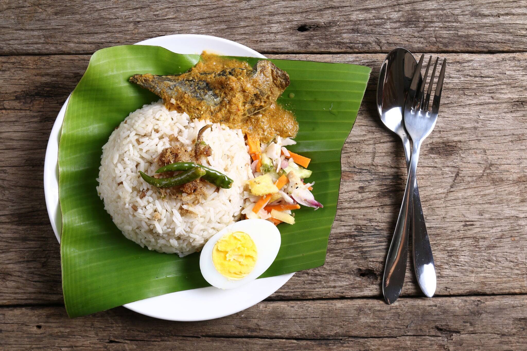 Nasi dagang, a popular Malaysian meal on the east coast of the Malaysian Peninsular. It consists of rice steamed in coconut milk, fish curry, hard boiled eggs and pickled vegetables.
