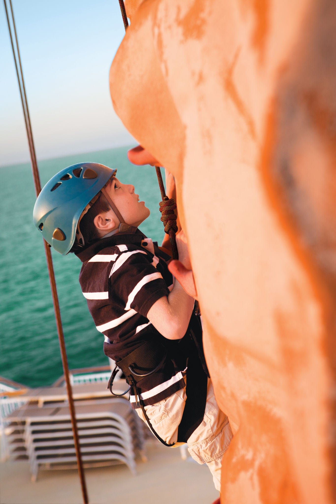 Boy climbing rock wall