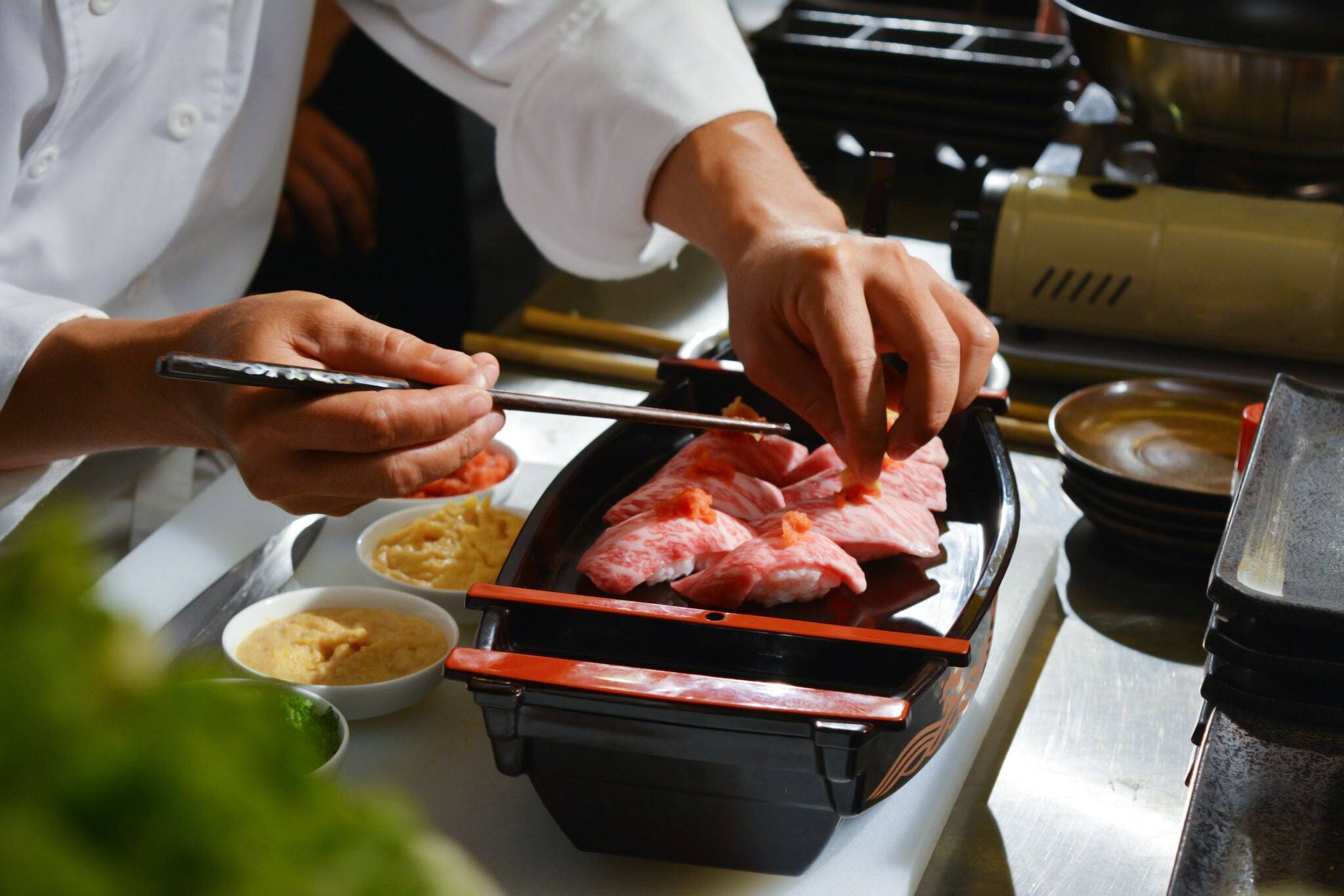 Chef making kobe sushi on boat, japanese wagyu beef sushi
