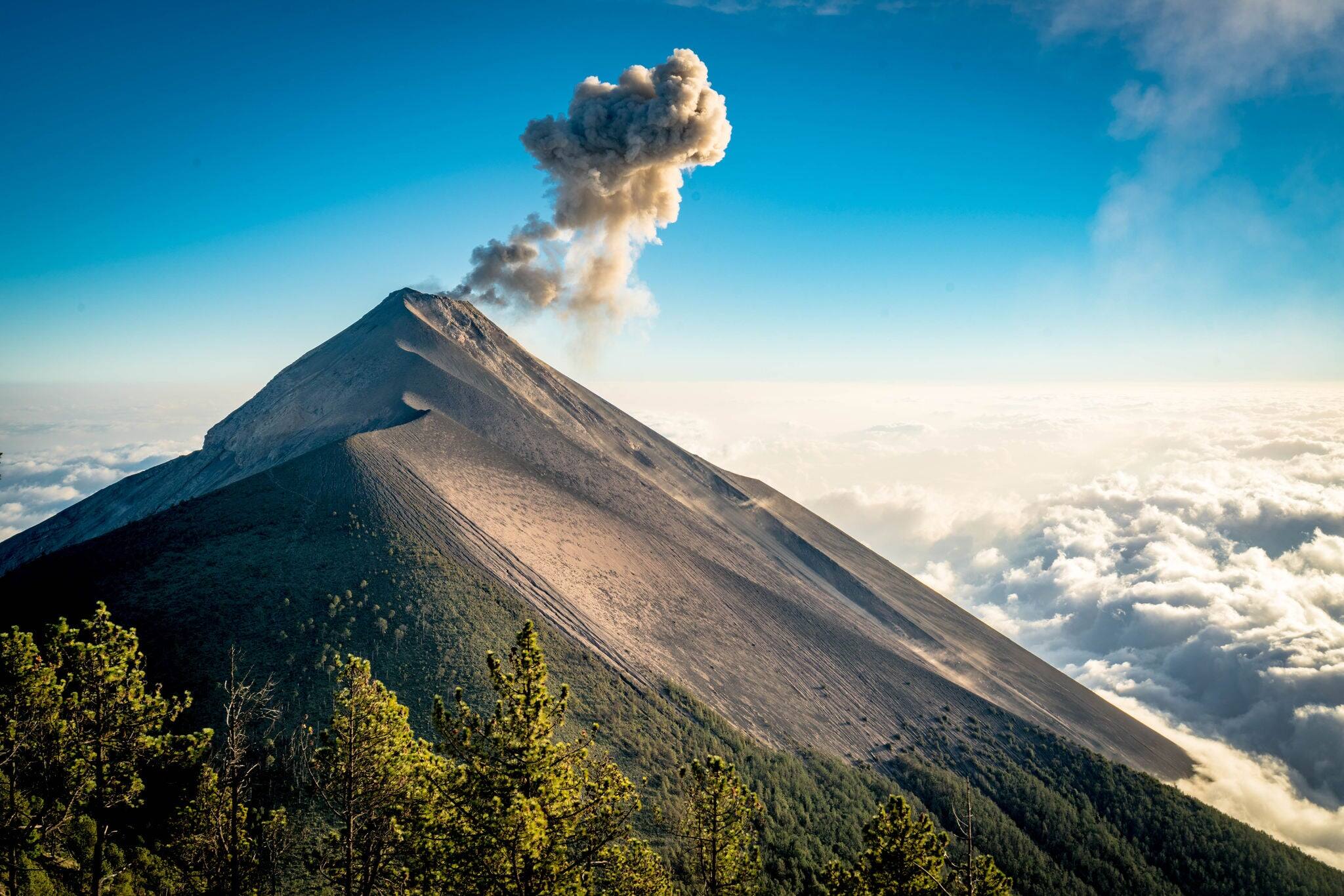 Eruption Hiking to Volcano in Guatemala Above Clouds at Sunset with Sky View and Trees in Nature Park