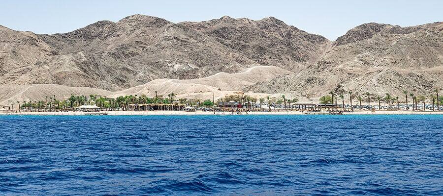 View of Red Sea with rock formations on the distant coast in Sokhna, Egypt.