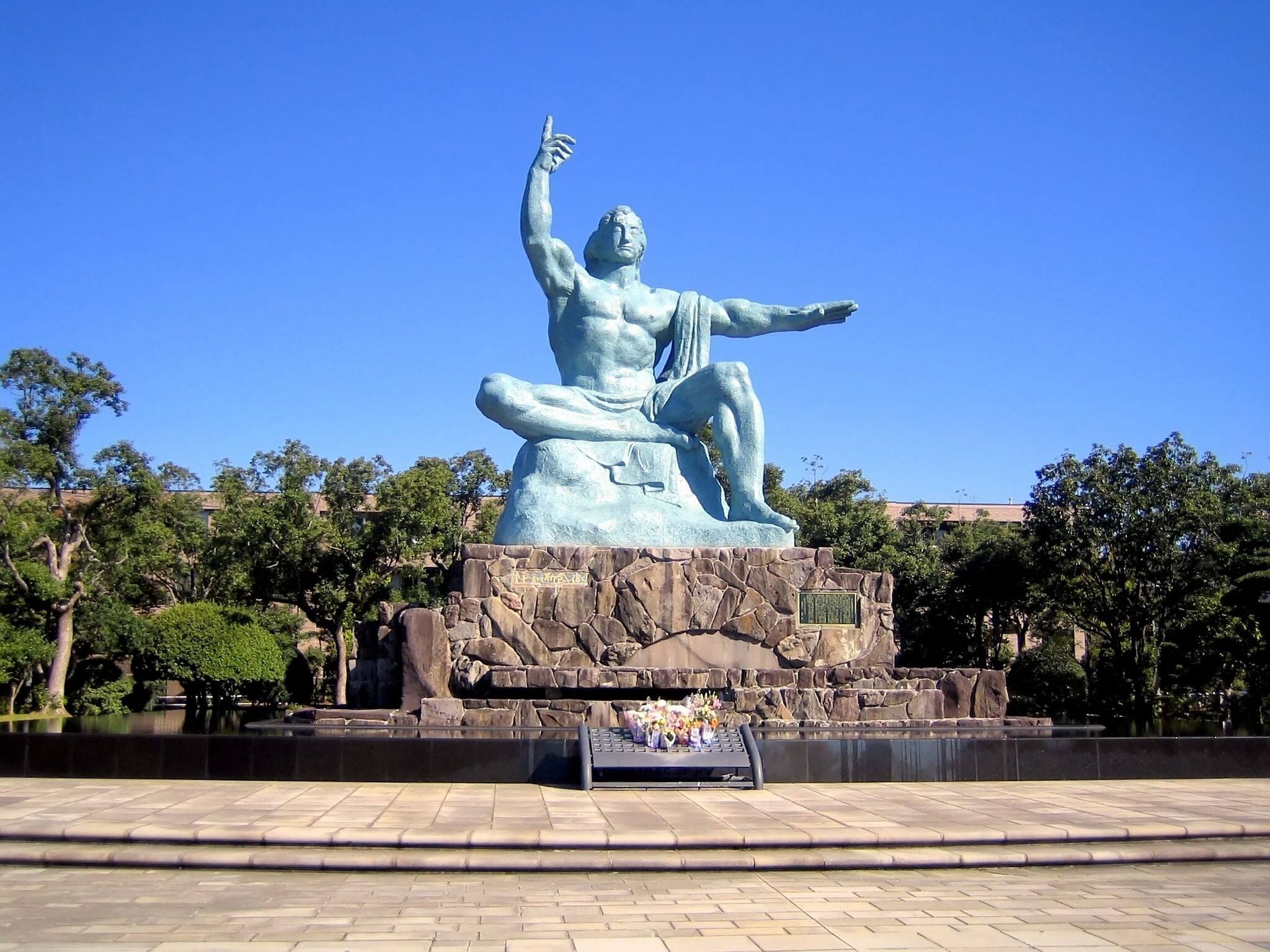 The Peace Statue in Nagasaki Peace Park, Japan on a cloudless day. The park commemorates the atomic bombing of the city on August 9, 1945. It is next to the Atomic Bomb Museum.