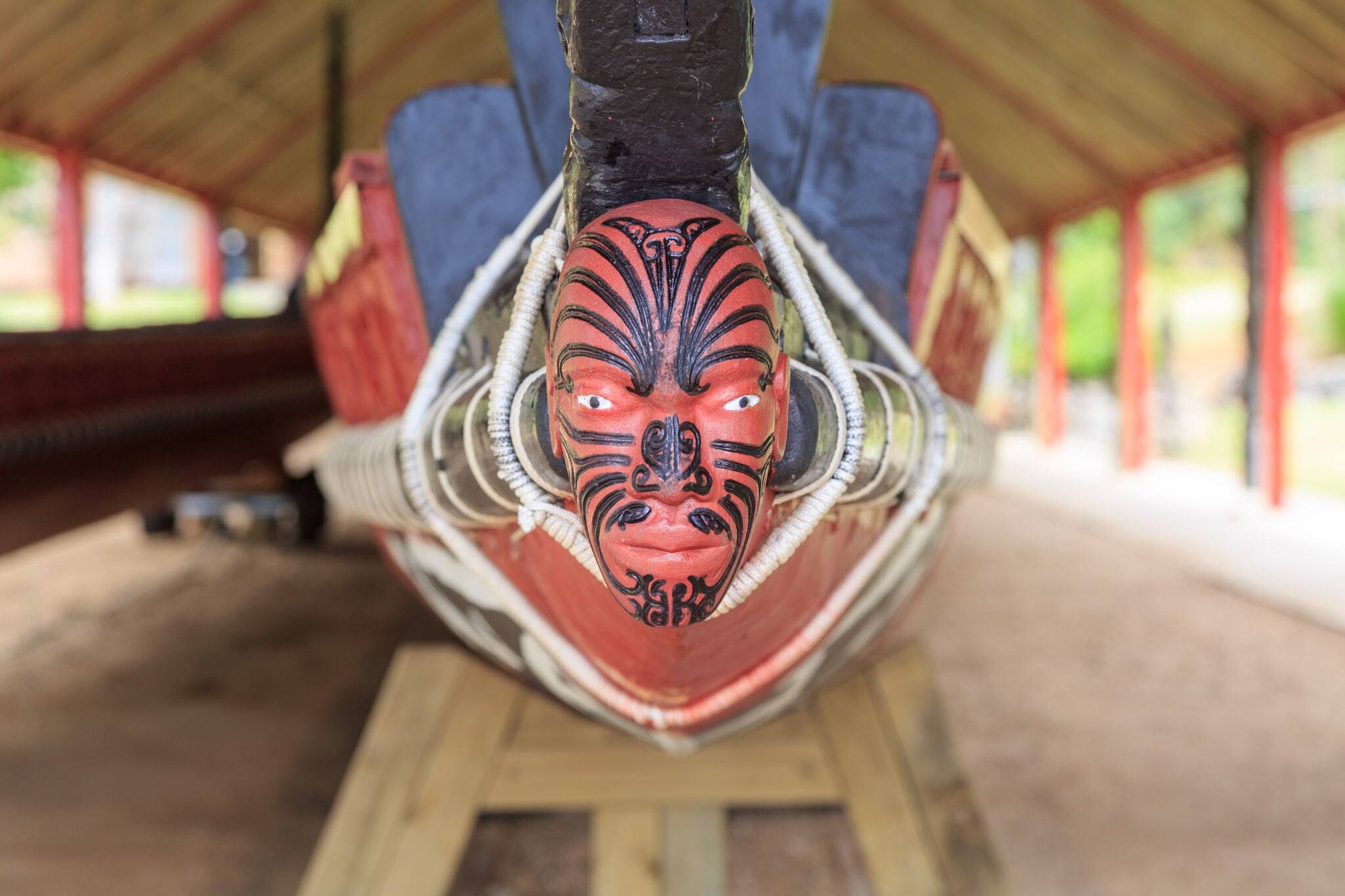 A typical maori puppet head with moko at the end of a war canoe in Waitangi, New Zealand
