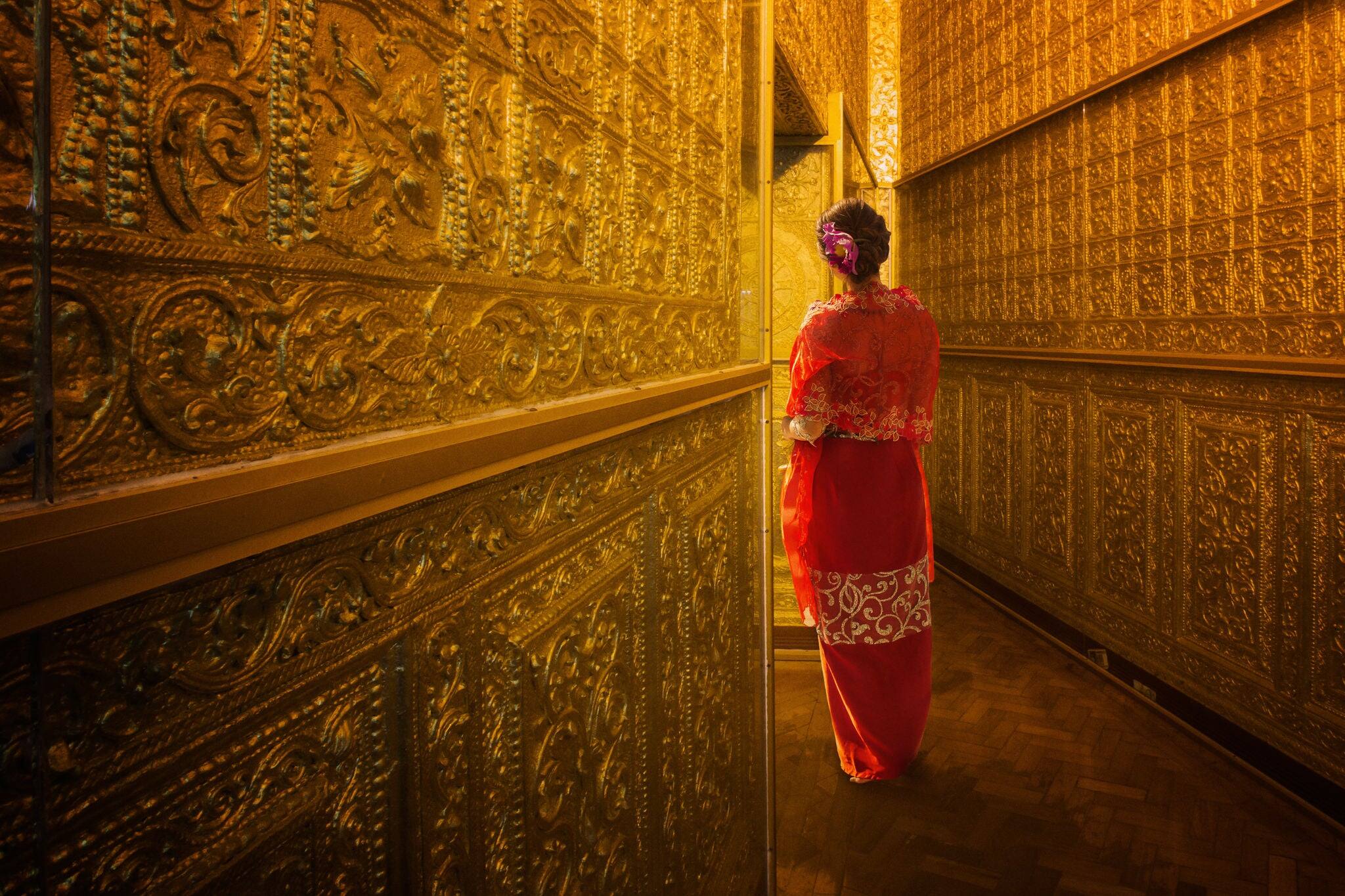 Myanmar lady atanding in the ancient emple in Yangon, Burma