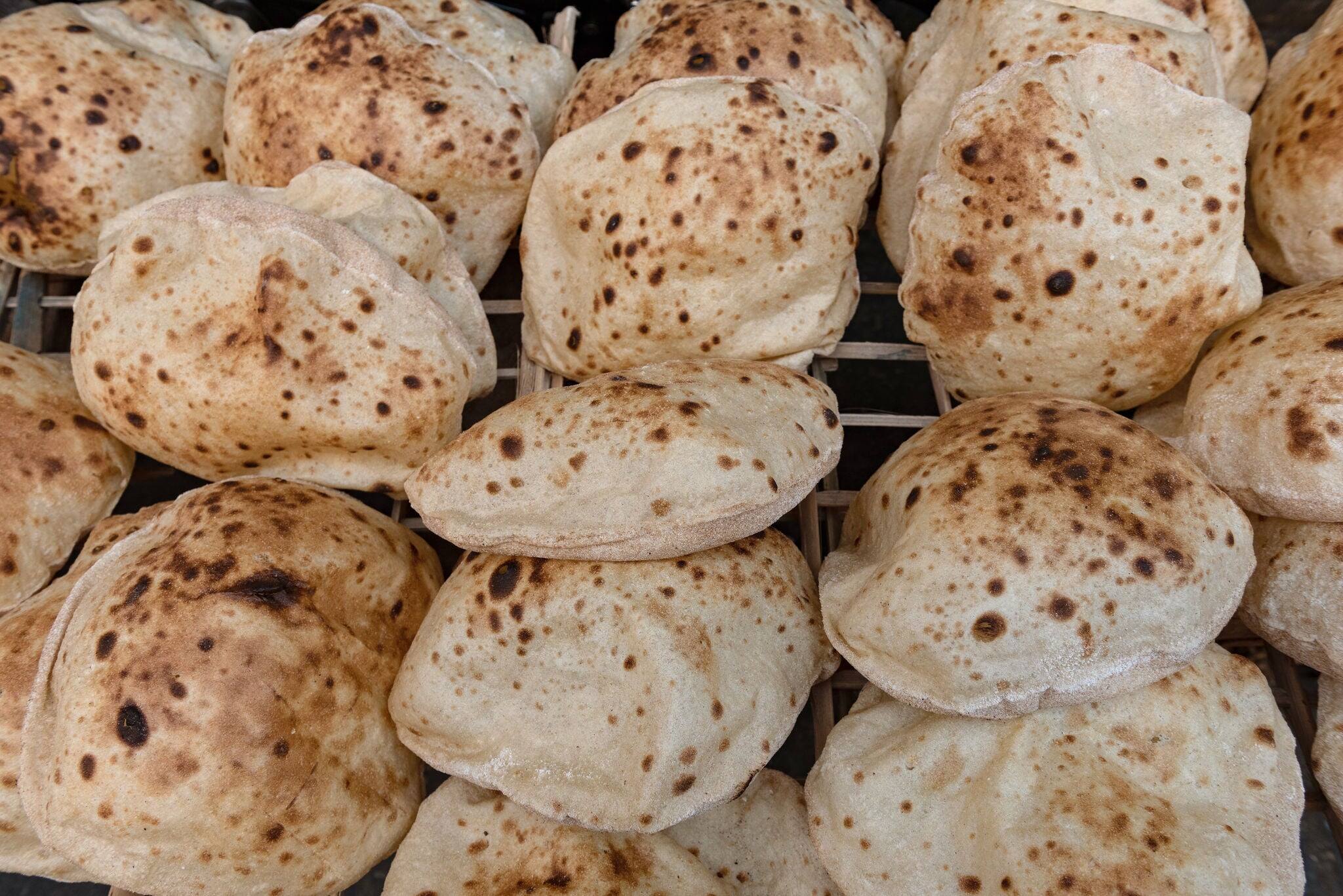 Freshly oven baked traditional Baladi flat bread, similar to pitta bread is a staple of Egyptian cuisine is cooked all over Egypt