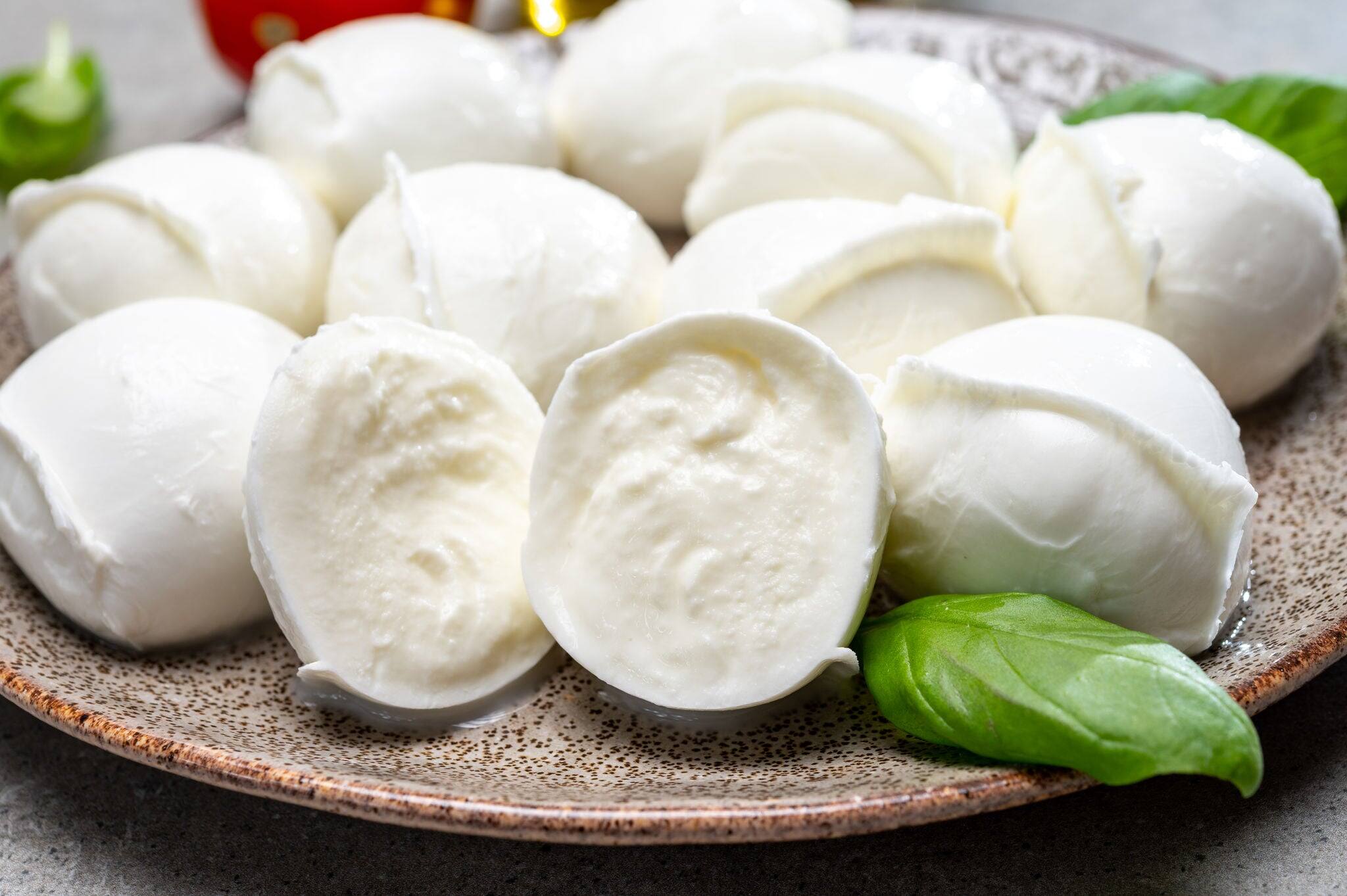 Tasty italian food, fresh white buffalo mozzarella soft cheese balls from Campania close up
