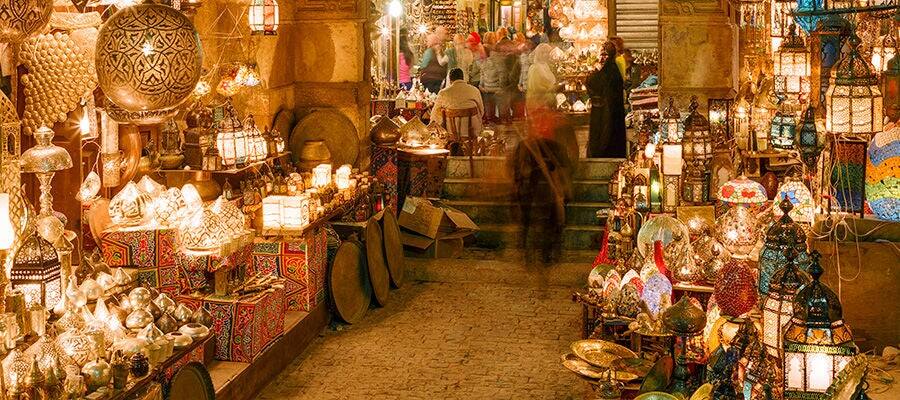 Illuminated lanterns in the Khan El-Khalili Bazaar market at night.