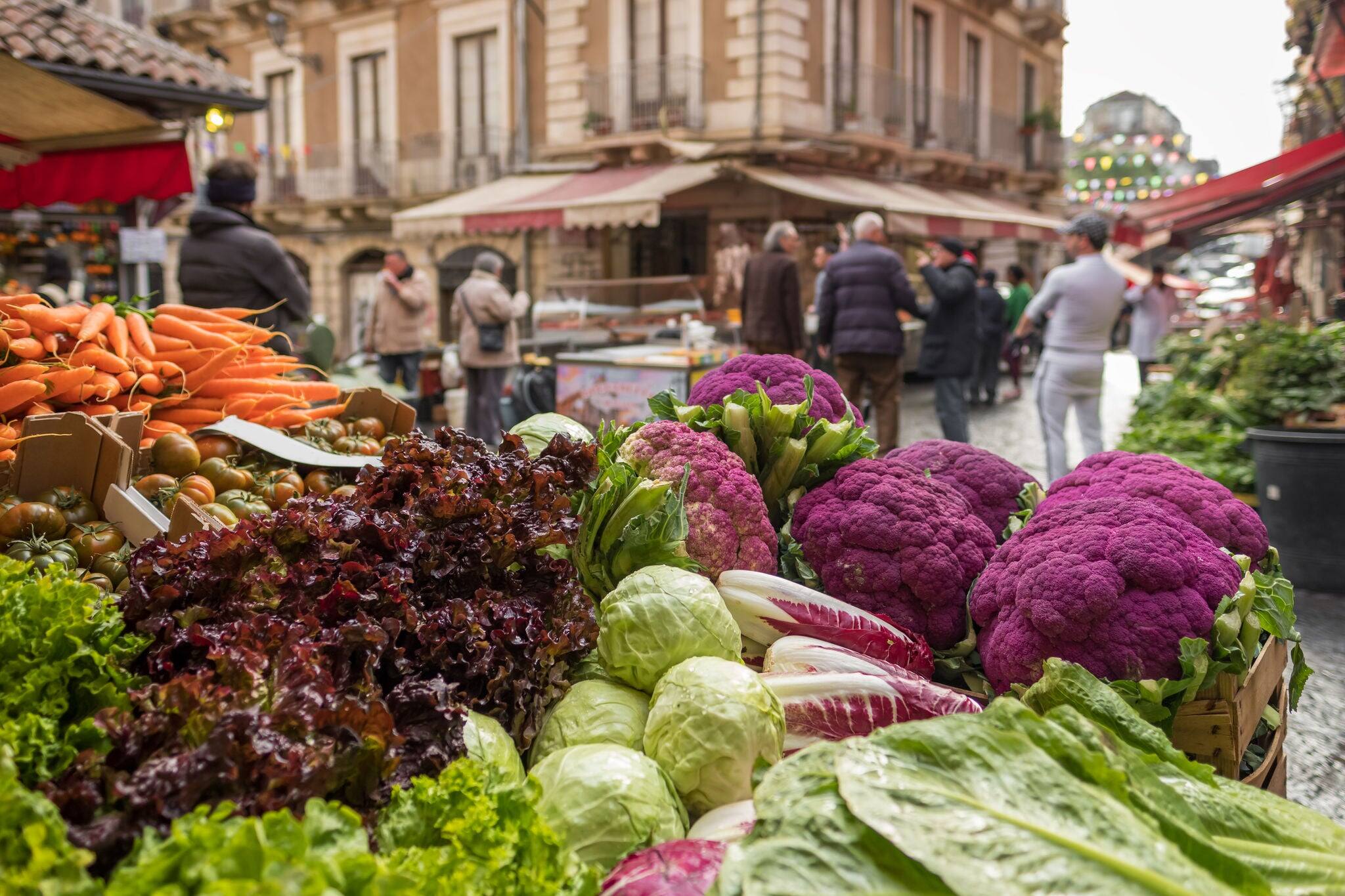 Fresh vegetables: cauliflower, salad, cabbage, carrot at famous Ballaro market in Palermo, Sicily, Italy