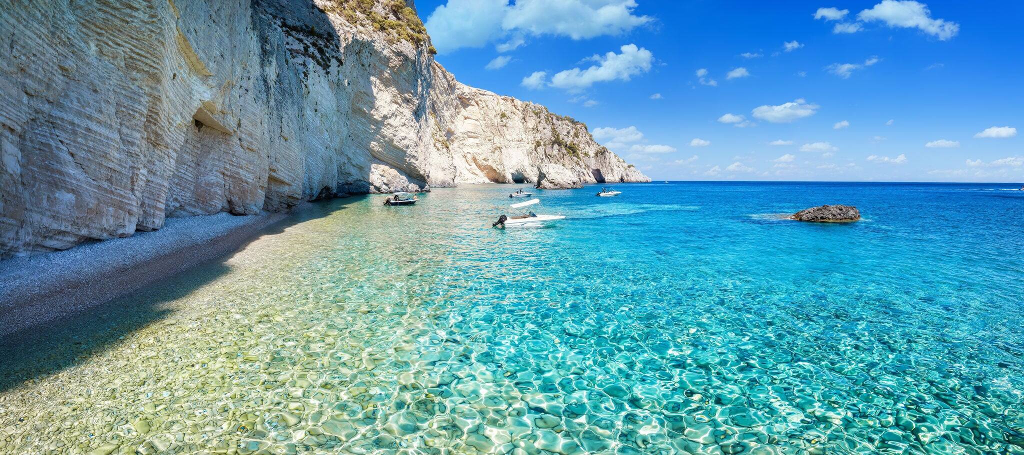 The remote coast at the Keri area, with shining, turquoise sea next to the steep cliffs at the Ionian island of Zakynthos, Greece