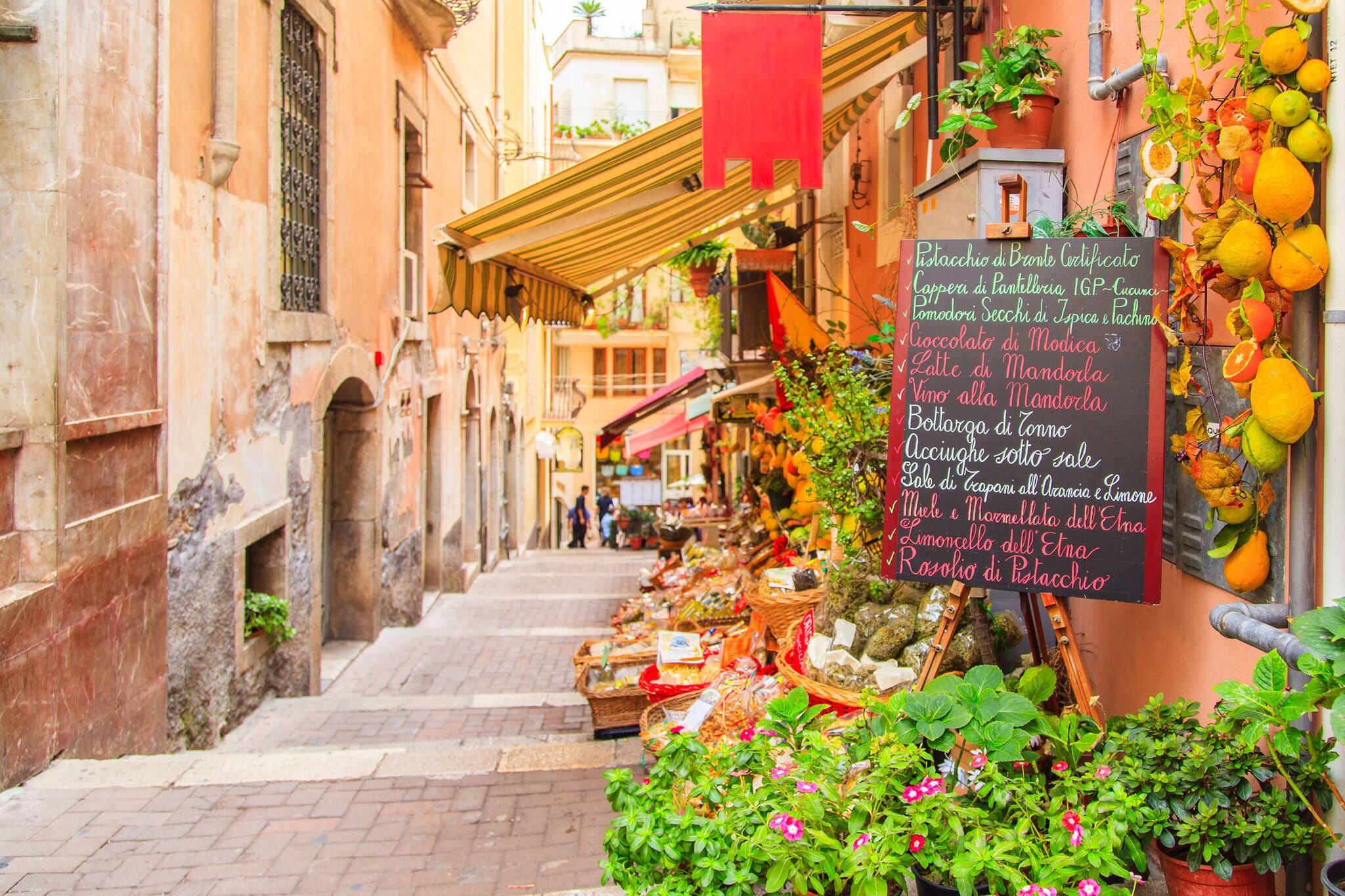 Entrance to local shop in Taormina, Sicily. Writing on the black table lists itmes on promotion.