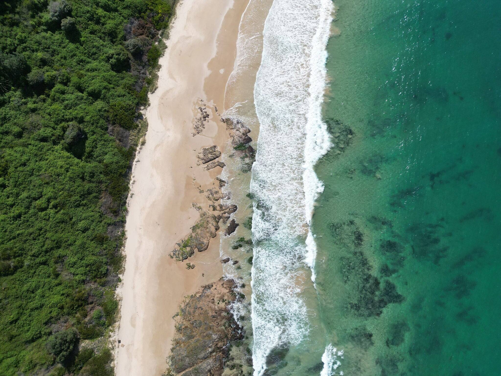 Ariel shot of  waves and landscape of MM beach from Hill 60, port Kembla, Illawarra, New South Wales, Australia