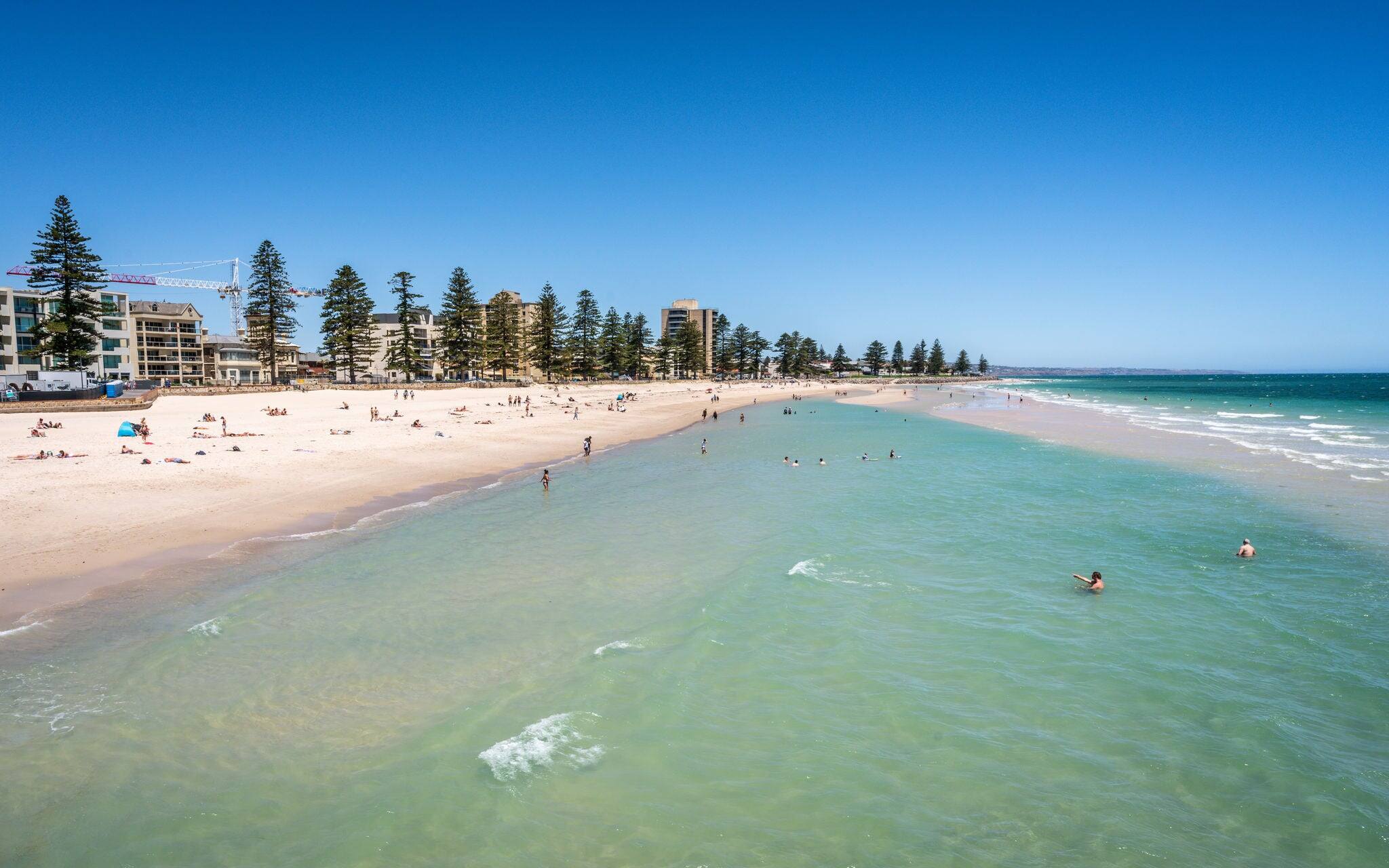 Distant view of Glenelg beach in Adelaide suburb on hot sunny summer day in South Australia