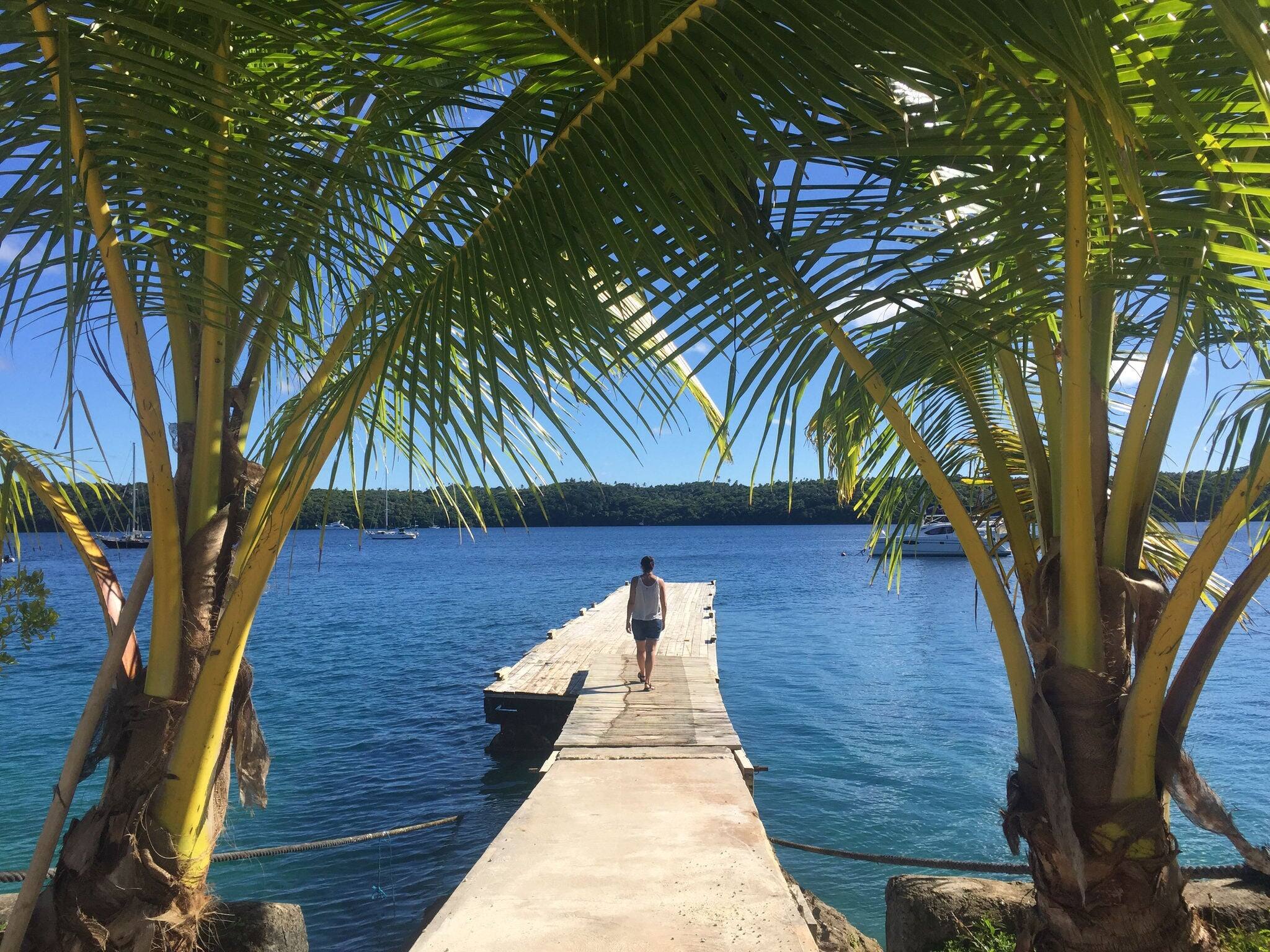 Girl between palms in Vava’u, Kingdom of Tonga.