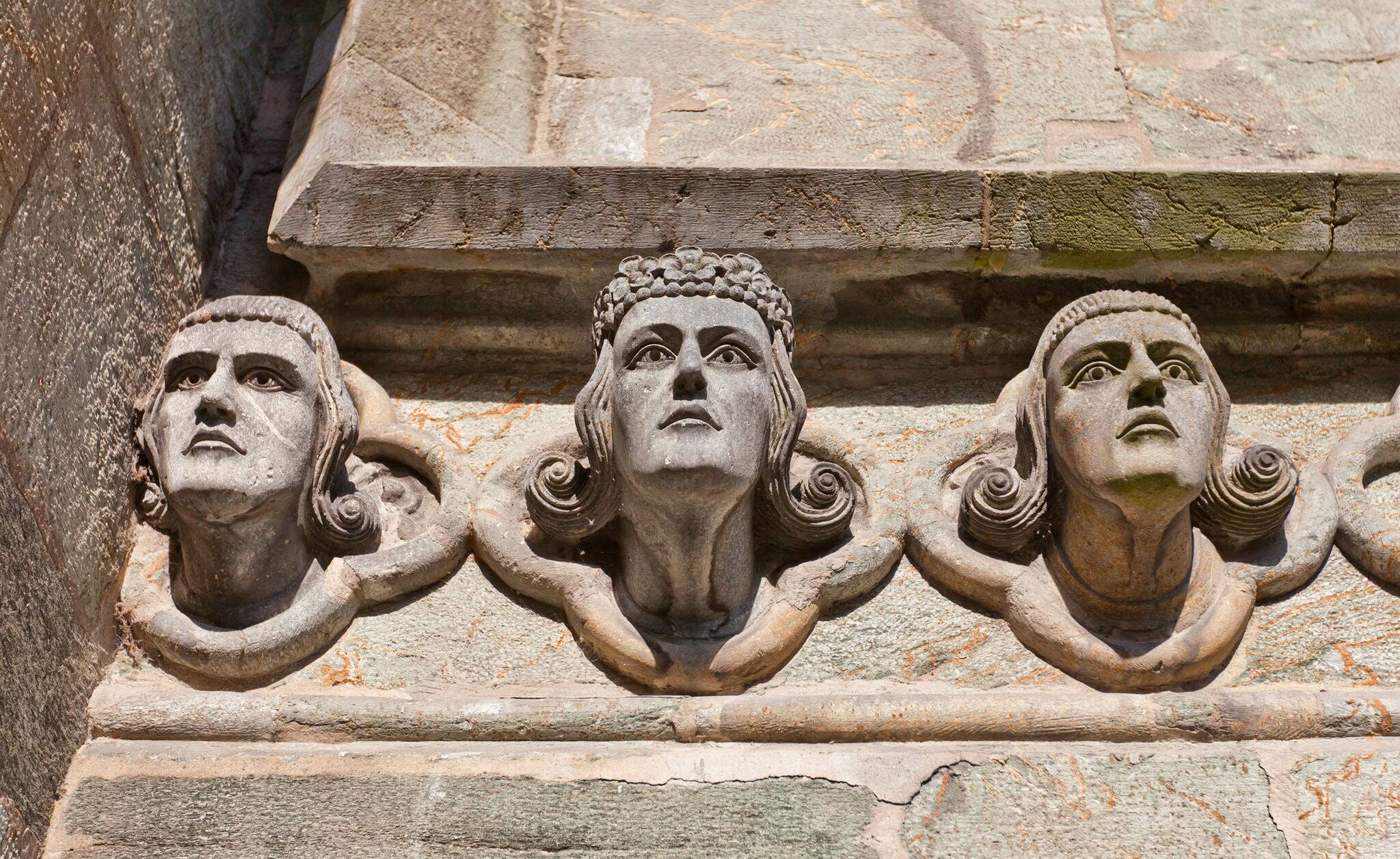 Head sculptures on east facade of Stavanger Cathedral (Stavanger domkirke, circa XIII c.), the oldest church in Norway