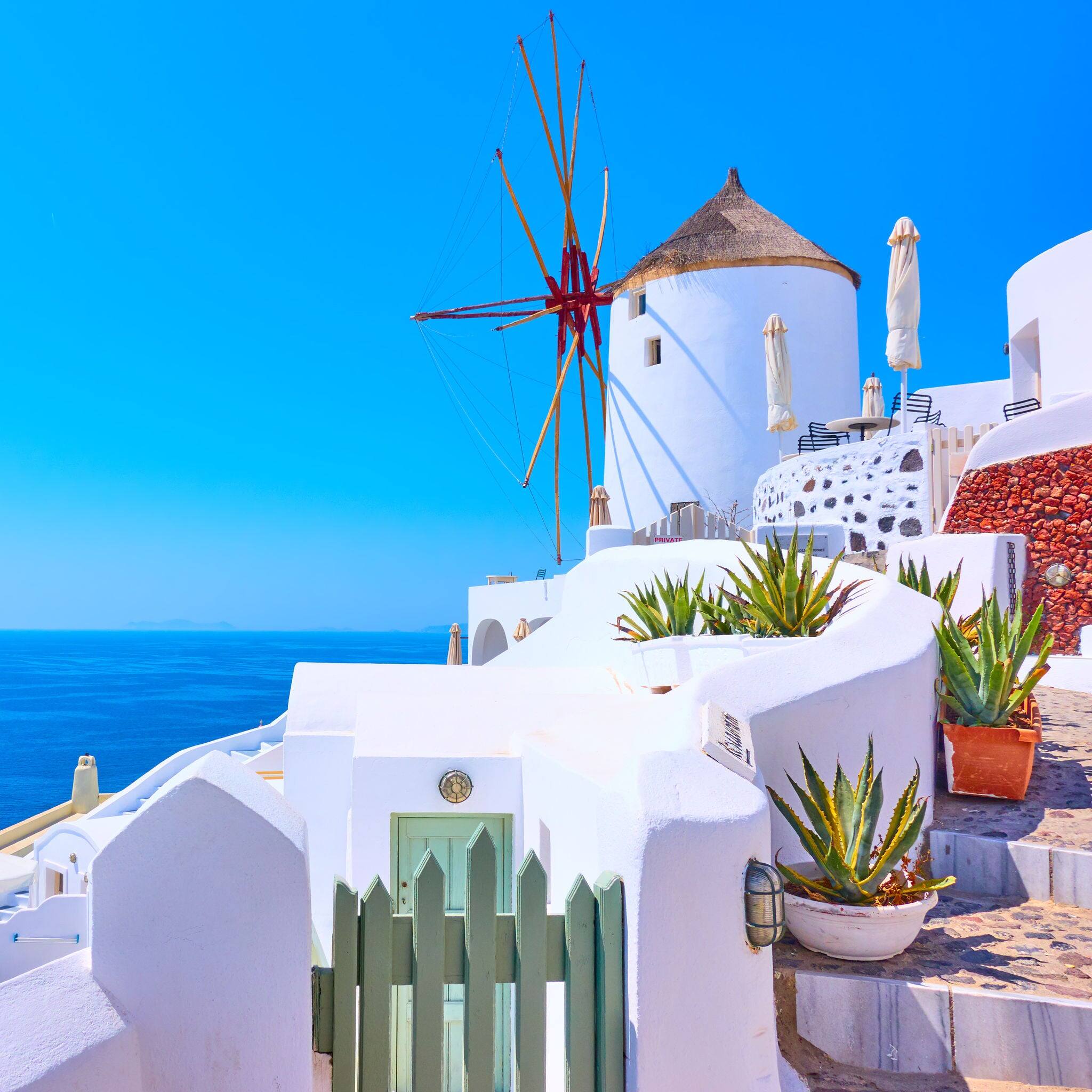 Old white windmill in Oia in Santorini, Greece